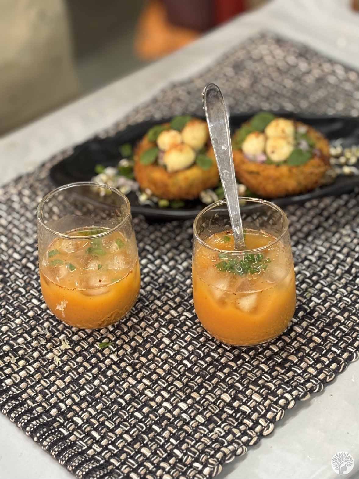 A close-up of Crispy Nest Potato Chaat and savory Sattu Summer Drink showcasing mindful plating and textured fusion ingredients.