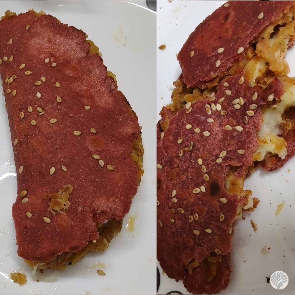 A side-by-side comparison of a homemade pink taco shell topped with sesame seeds, showing it whole on the left and cracked open with a potato-cheese filling on the right.